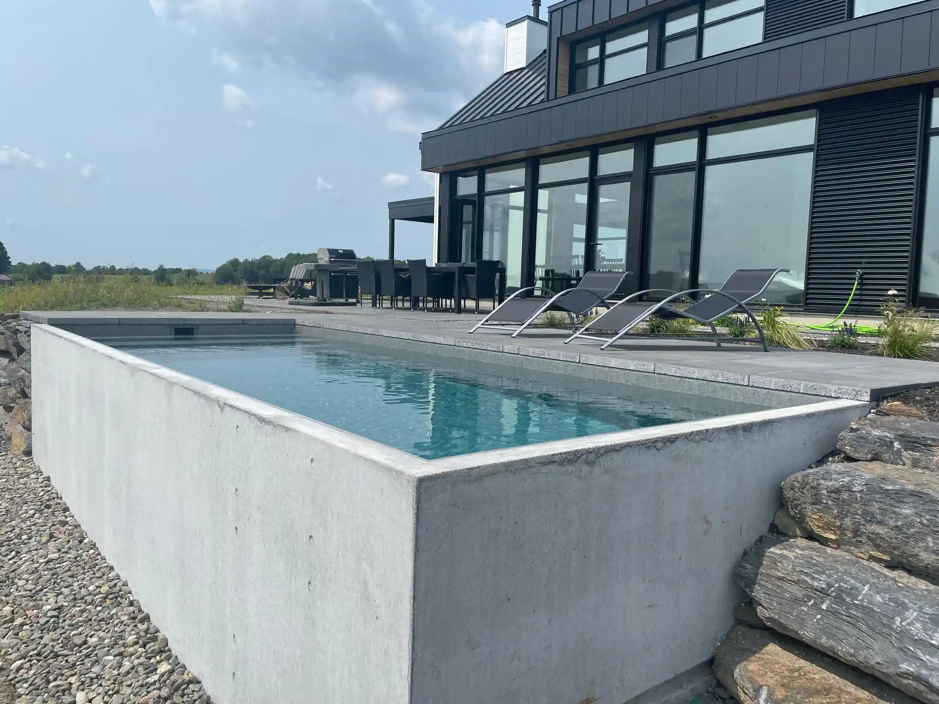 Backyard pool surrounded by custom hardscaping